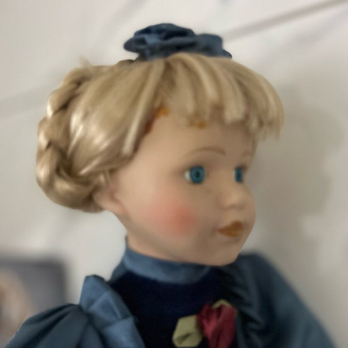 Porcelain doll like new vintage with blue satin dress