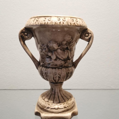 Faience amphora used with embossed design and cupids