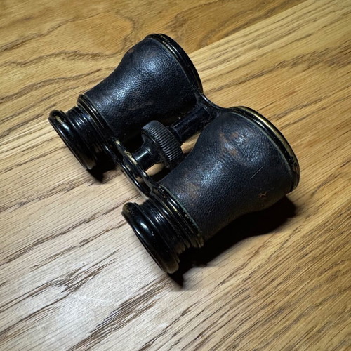 Vintage French binoculars used with leather covering good condition