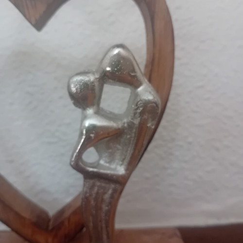 Decorative wooden heart sculpture with couple figure