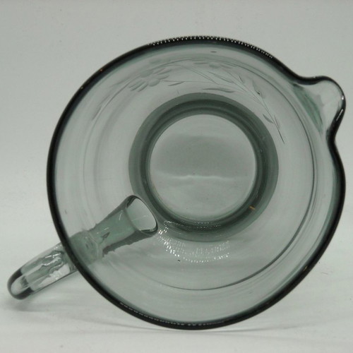 Vintage water pitcher made of blown glass used, gray with floral engravings