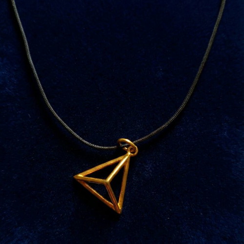 Necklace with gold charm used, black cord