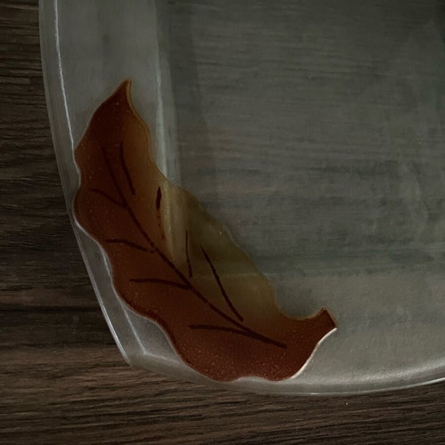 Decorative glass tray used with embossed leaf design