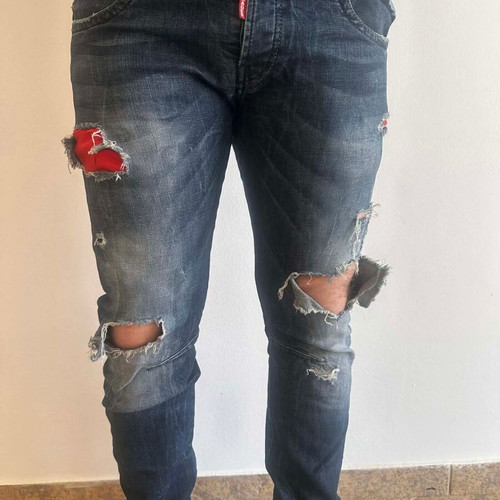 Damaged Jeans pants used with rips, blue and red