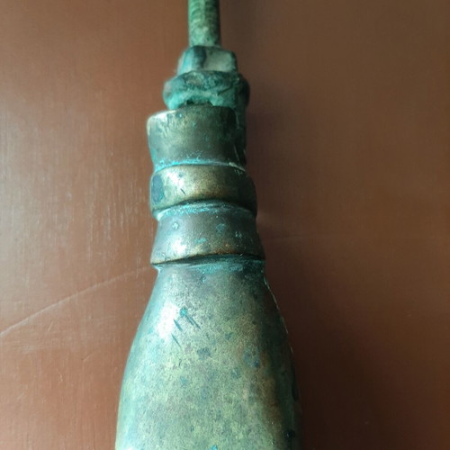 Antique bronze door knocker in hand shape