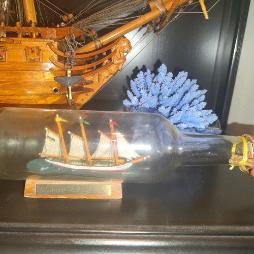 Ship in a bottle used with sealed top and wooden base