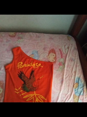 Sleeveless orange top with print used