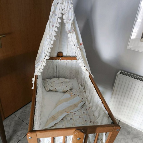 Wooden baby cot like new with wheels and mosquito net