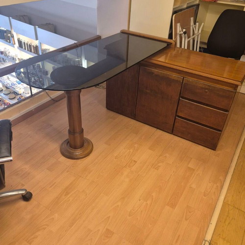 Corner desk with glass surface used, wooden base and storage
