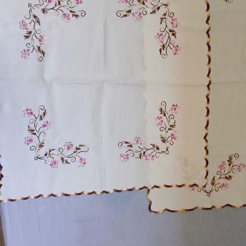 Vintage cream linen table linens set with pink floral cross-stitch embroidery and scalloped edge
