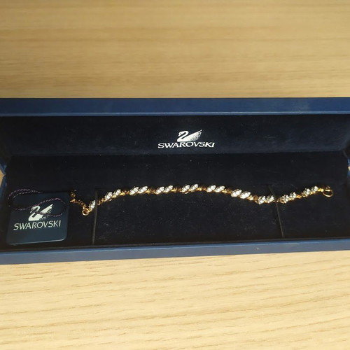 Swarovski bracelet like new, gold tone with crystals