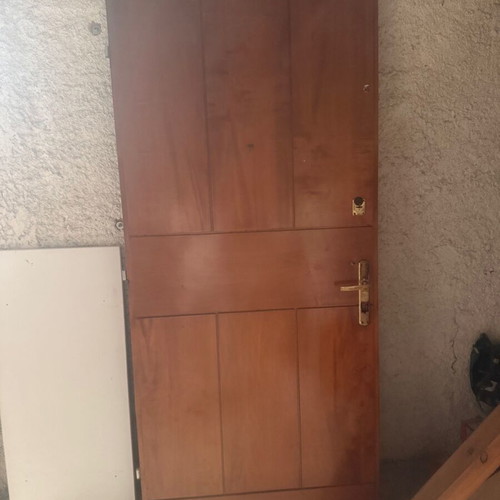 Wooden entrance door used with locks and golden handle