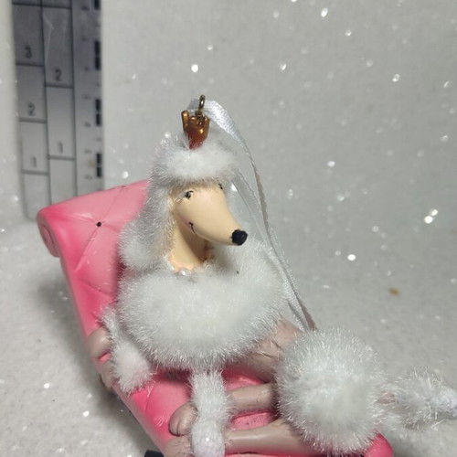 Dog ornament on chaise lounge, hanging decoration