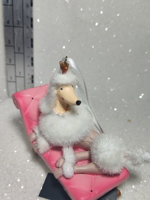 Dog ornament on chaise lounge, hanging decoration