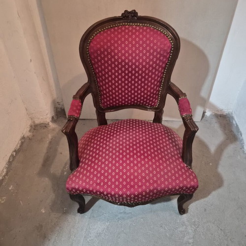 Armchair with carved wood frame and red fabric