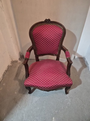 Armchair with carved wood frame and red fabric