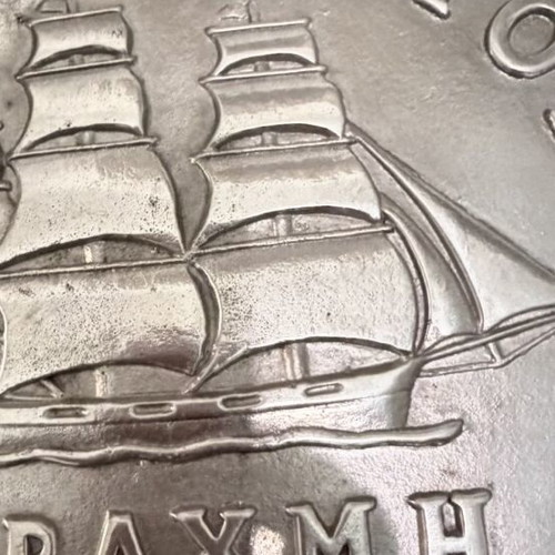 Decorative embossed drachma coin