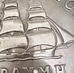 Decorative embossed drachma coin