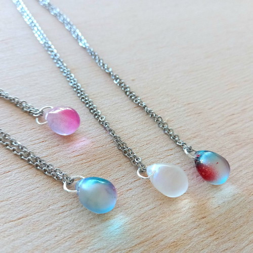 Handmade pendants from iridescent glass and steel