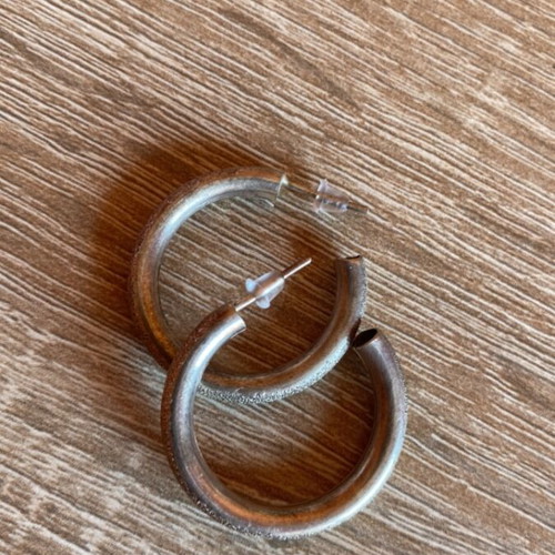 Pair of silver earrings used with textured design