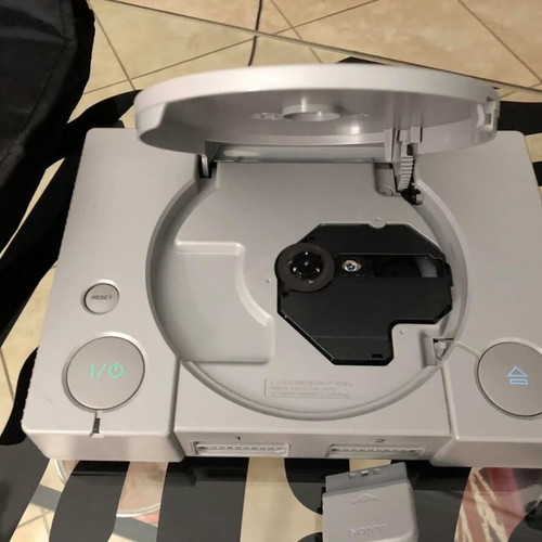 Sony PlayStation console used with official bag, controller and cables