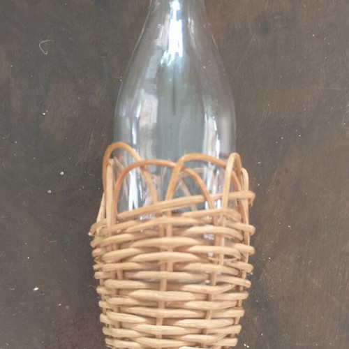 Miniature vintage bottle with wicker covering
