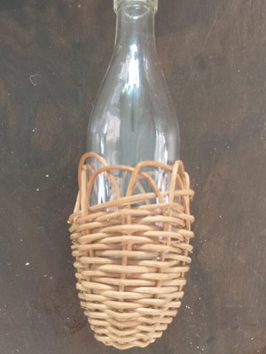 Miniature vintage bottle with wicker covering