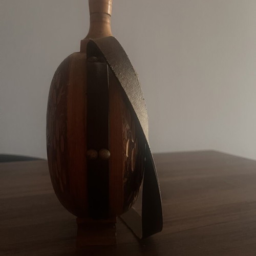 Wooden flask used with carved decoration and leather strap