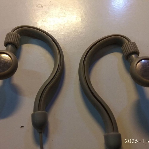 Over the ear headphones used with anatomical tube behind the ear