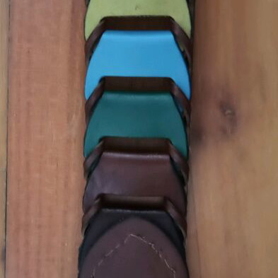 Colorful woven belt in warm shades made of faux leather, like new