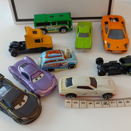 Set of 9 used toy cars including Disney Pixar models, metal and plastic