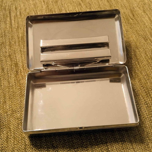 Tobacco case and metal cigarette roller used