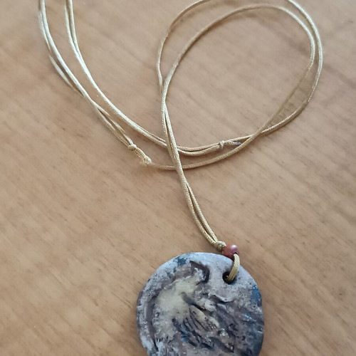 Ceramic handmade necklace like new with embossed dove and cord