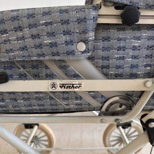 Vintage baby stroller with classic check fabric and metal frame