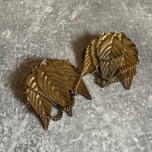 Gold-colored earrings used with flowers