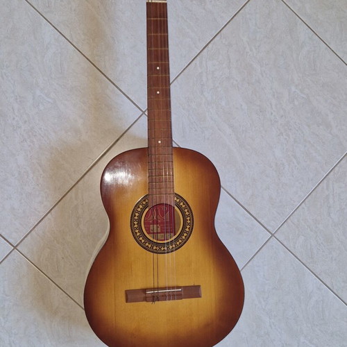 Classical guitar used with case, missing one string and small hole