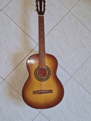 Classical guitar used with case, missing one string and small hole