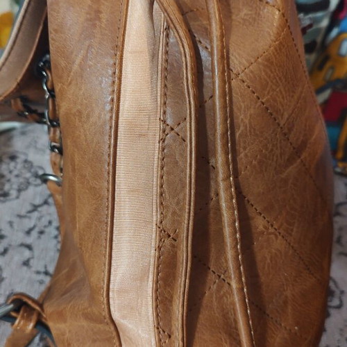 Quilted women's backpack in tan with chain detail