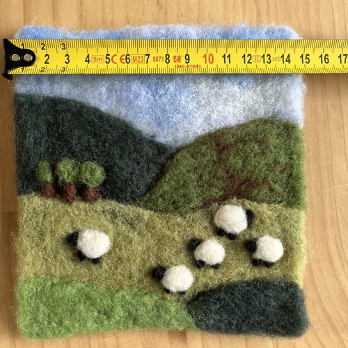Handmade wool felt landscape picture with sheep