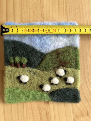 Handmade wool felt landscape picture with sheep