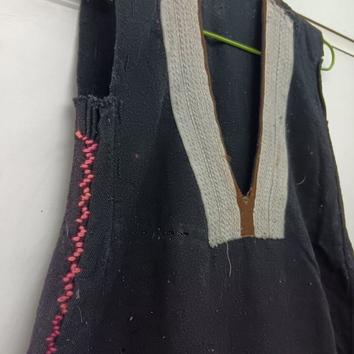 Traditional collectible wool dress used with wear due to age