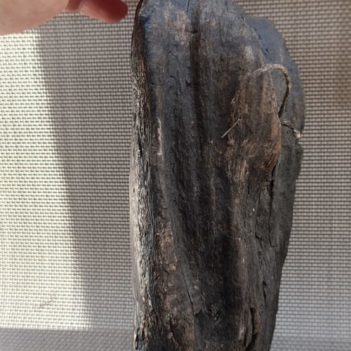Old religious icon on wood trunk, handmade