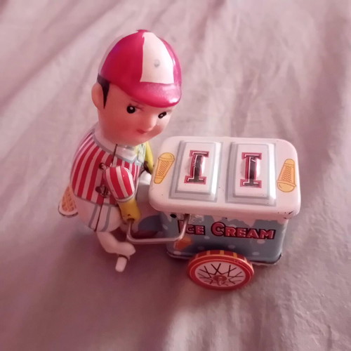 Vintage tin wind-up ice cream seller toy