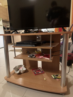 TV stand used with wheels and shelves for devices