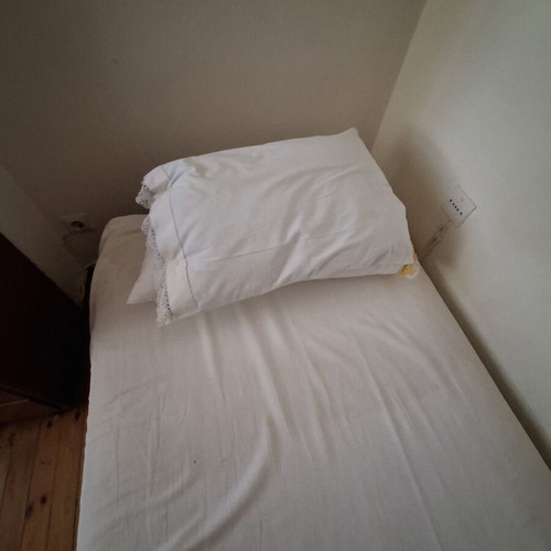 Single bed used with mattress and pillow