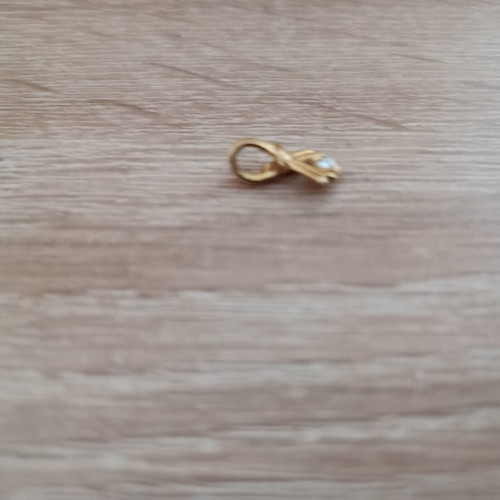 Gold-colored pendant with white stone used, vintage style