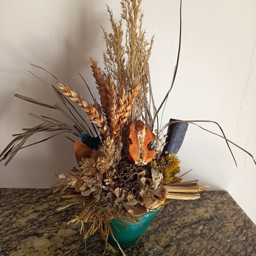 Vintage handmade decorative arrangement with dried stalks used