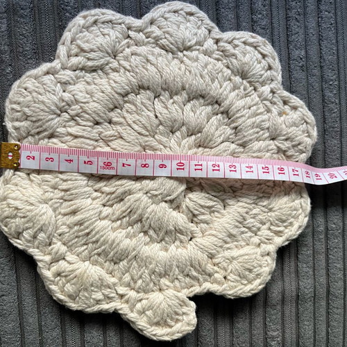 Knitted coaster used, flower-shaped, beige