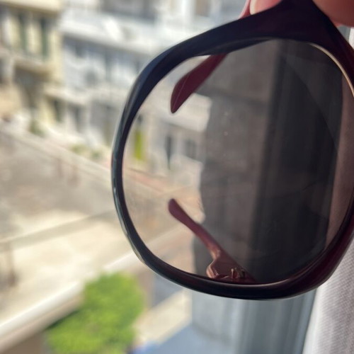 Christian Dior sunglasses used, black and red frame, lens scratched