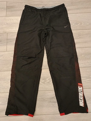 Nike Athletic Y2K Track Pants used, black with red swoosh logo